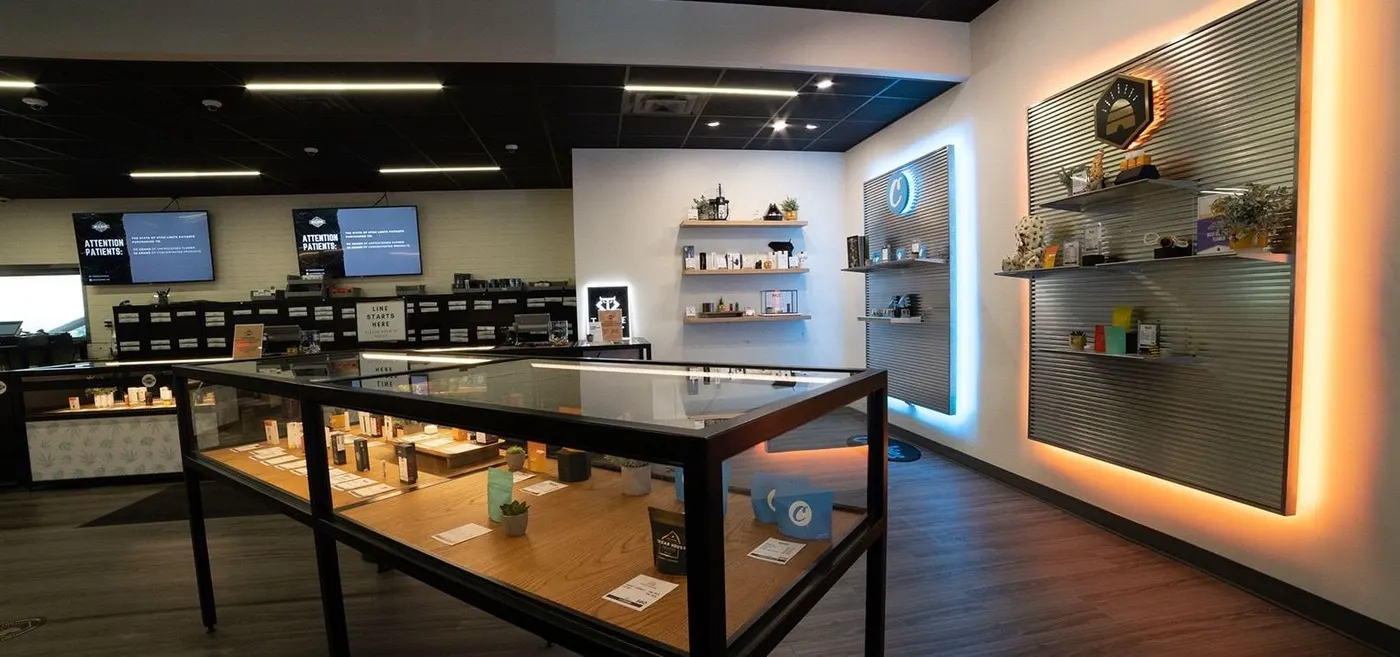 Interior of Beehive Farmacy cannabis dispensary with glass display cases and product shelves